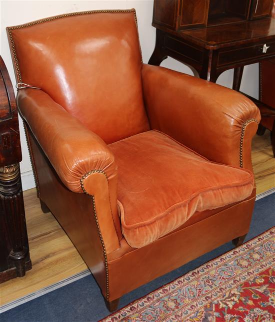 A pair of 1940s French russet leather club armchairs, W.2ft 7in. D.2ft 10in. H.2ft 8in.